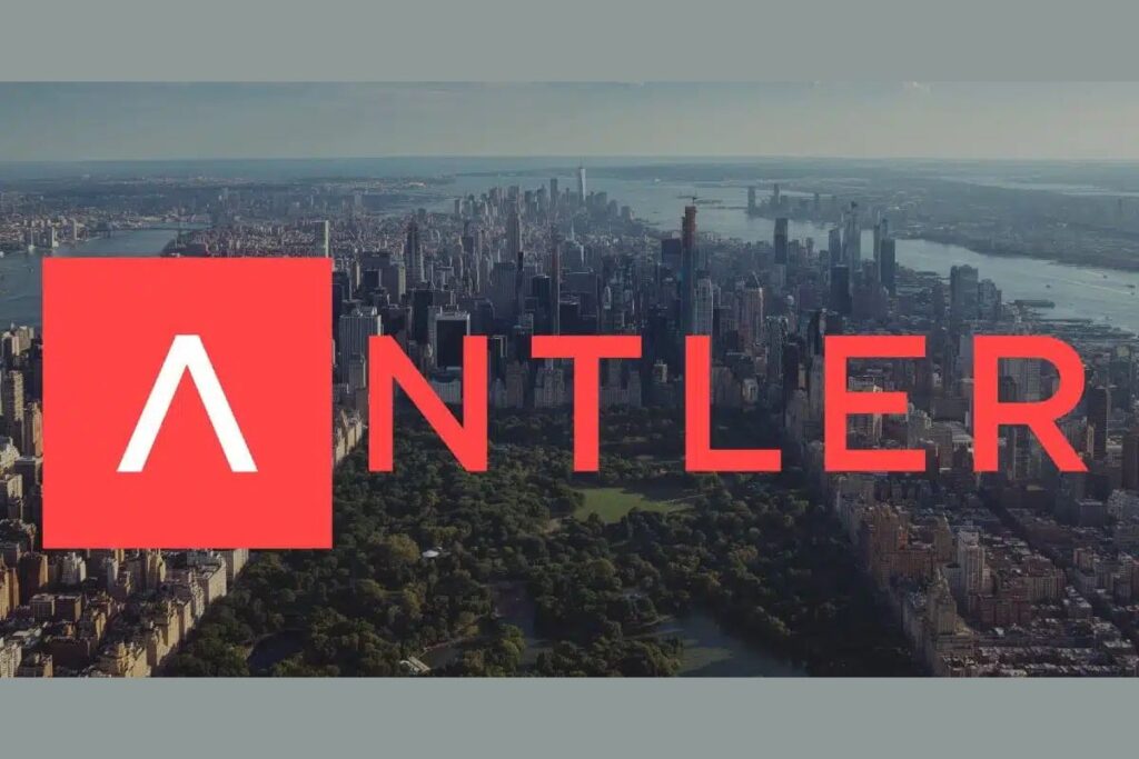 A modern workspace at Antler, showcasing an open-concept design with founders working on their startups, engaging in discussions, and utilizing shared resources.