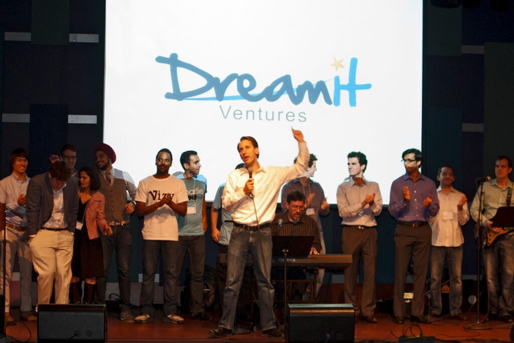 Founders presenting their cybersecurity startups on stage at Dreamit Accelerator’s Demo Day, with investors and an audience in attendance.