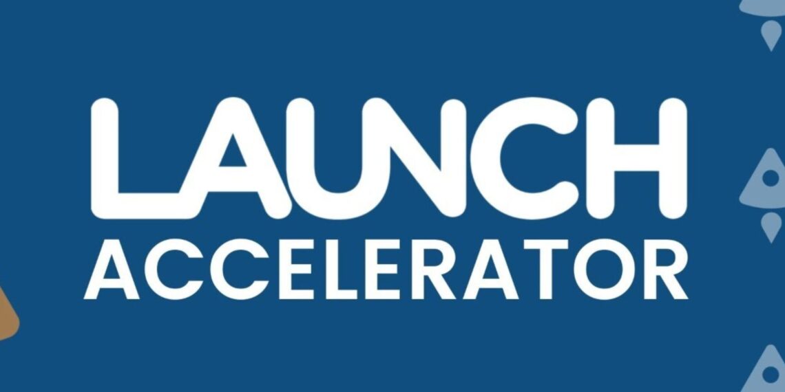 An image showing a group of startup founders collaborating in a modern workspace, with the LAUNCH Accelerator logo displayed in the background. The scene captures an energetic and innovative environment, representing the accelerator's focus on funding, mentorship, and growth for early-stage startups.