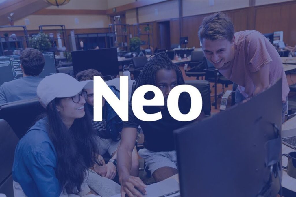 An image showing a group of founders working together in a collaborative workspace, with the Neo Accelerator logo displayed, symbolizing mentorship and startup growth.