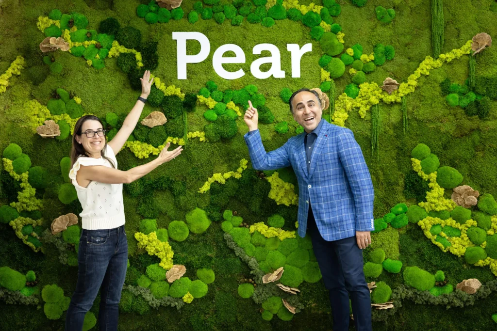 get into PearX accelerator founders standing under Pear sign representing access to PearX program