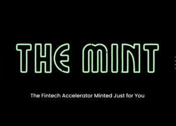 A professional workspace with fintech founders collaborating, discussing strategies, and reviewing financial data on laptops. The The Mint Accelerator logo is prominently displayed, representing BTV’s fintech-focused pre-seed program.