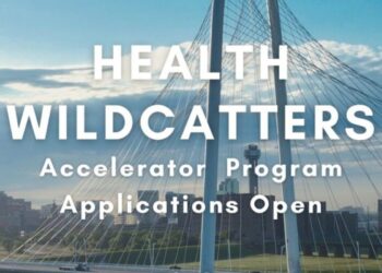The Health Wildcatters logo displayed prominently on a modern office wall, symbolizing innovation in healthcare entrepreneurship.