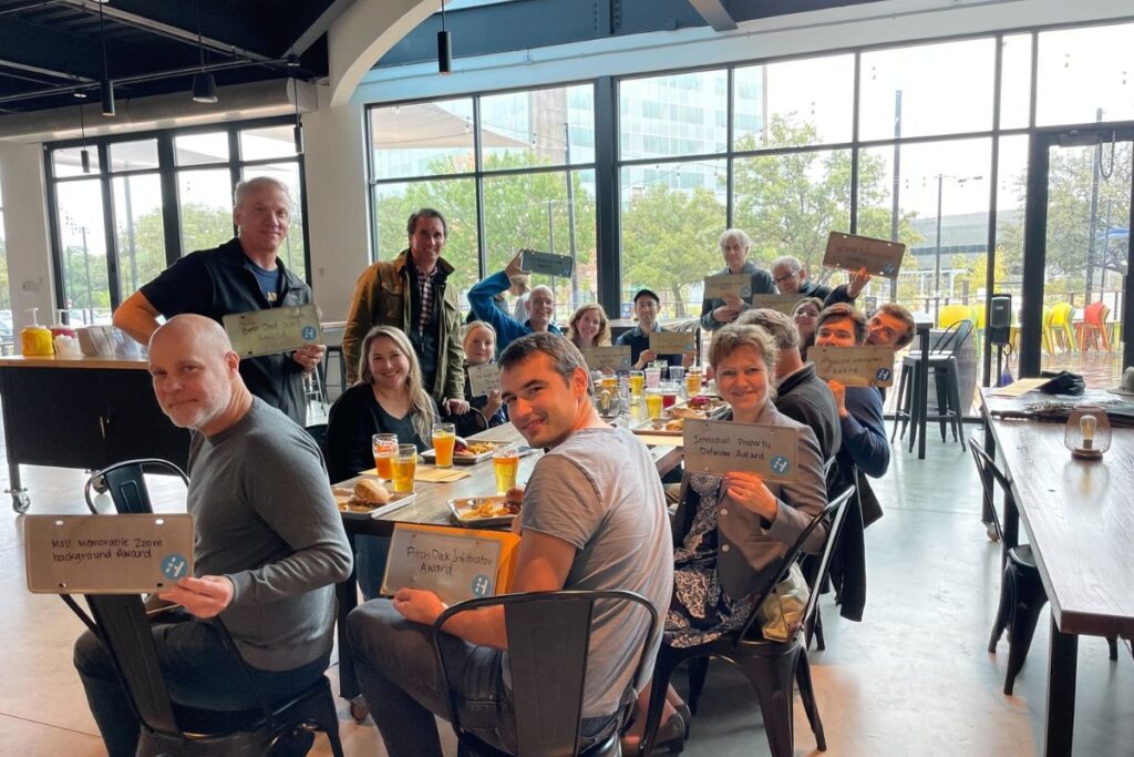 A group photo of selected healthcare startup founders posing together inside the Health Wildcatters office, smiling after being accepted into the accelerator program.