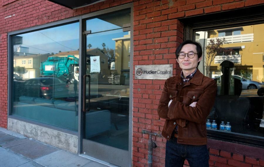 MuckerLab Accelerator Office – A modern, well-lit office space with startup teams working collaboratively, featuring desks, laptops, and a professional workspace environment.