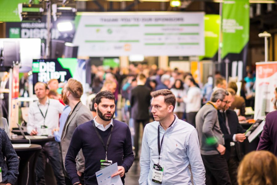 A group of Startup Battlefield participants networking and preparing their presentations at the TechCrunch Disrupt venue.