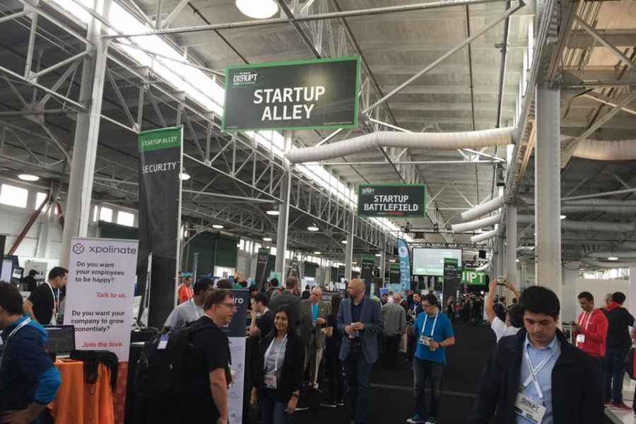 Various startup booths showcasing products and services inside the TechCrunch Startup Battlefield expo area.