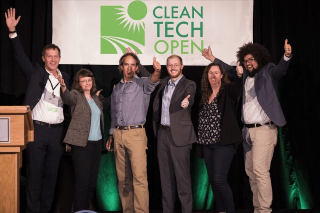 A dynamic scene from Cleantech Open’s Demo Day event, featuring startup founders pitching their innovations to investors and industry experts.
