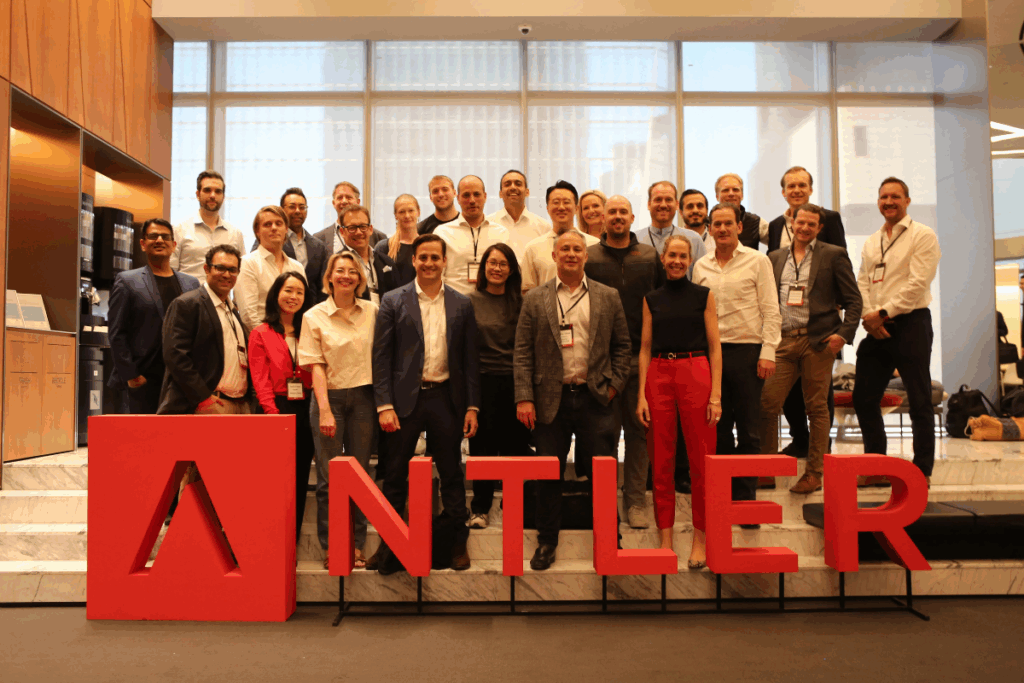 A group photo of the Antler accelerator team, showcasing a diverse and dynamic team of startup advisors, mentors, and founders collaborating.