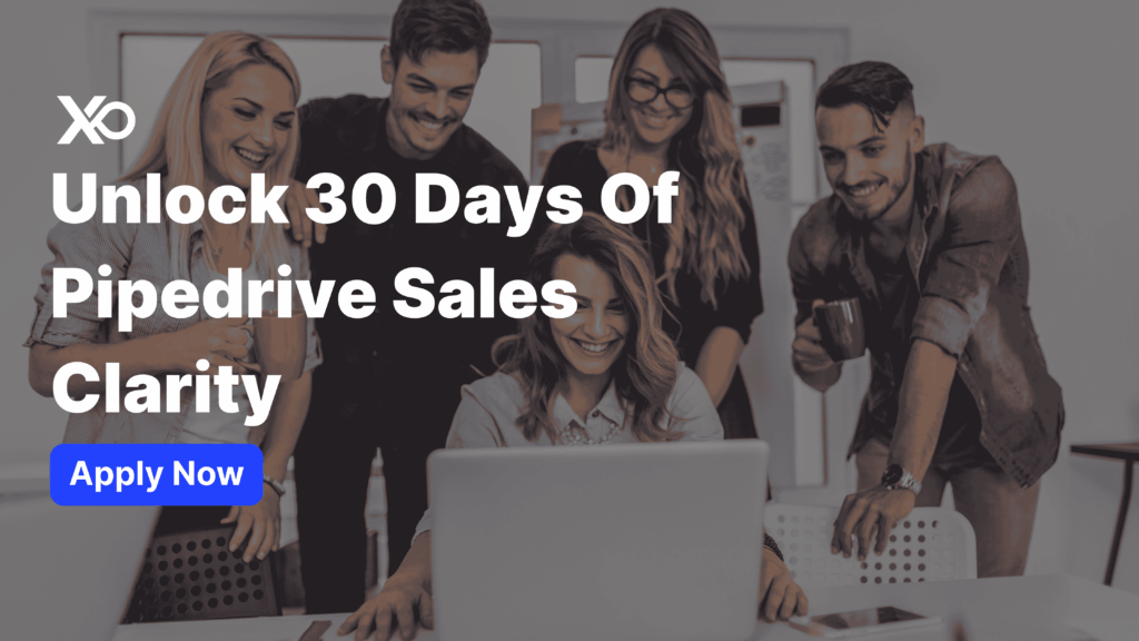 Startup team smiling around a laptop next to headline offering 30-day Pipedrive free trial for sales clarity