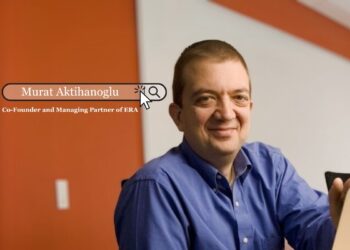 Murat Aktihanoglu standing in front of a city skyline, representing his role as Co-Founder and Managing Partner of Entrepreneurs Roundtable Accelerator (ERA).