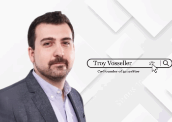 Troy Vosseller standing confidently in front of a gener8tor-branded backdrop, symbolizing leadership and startup mentorship.