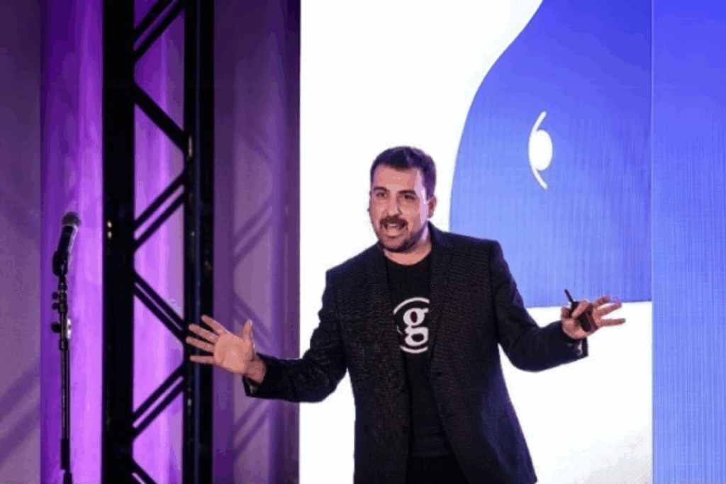 Troy Vosseller speaking to an audience at a startup event, gesturing as he shares insights on entrepreneurship and building ecosystems.