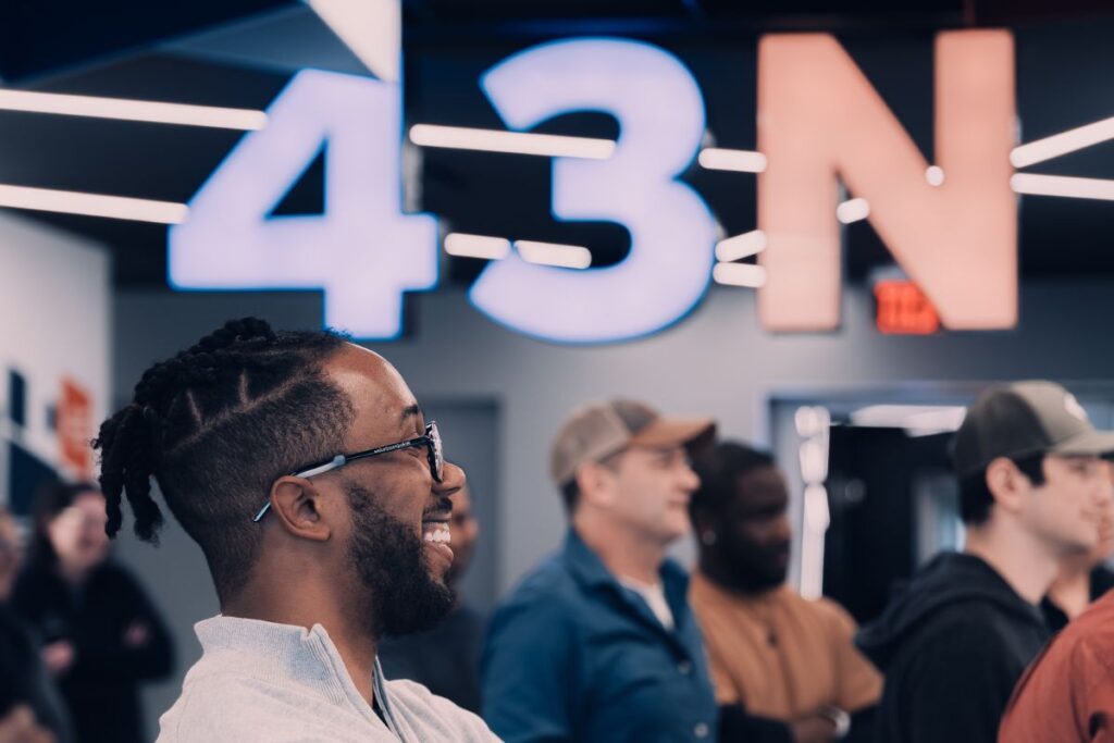 Professional 43North Accelerator team photo showcasing diverse members collaborating in a modern office space to support startup founders and entrepreneurial success.
