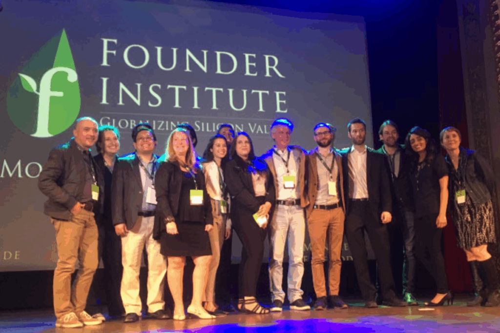 Group photo of top-performing graduates from a Founder Institute cohort holding certificates or awards.