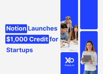 Startup founders collaborating on laptops, promoting Notion’s $1,000 credit for startups through XRaise.