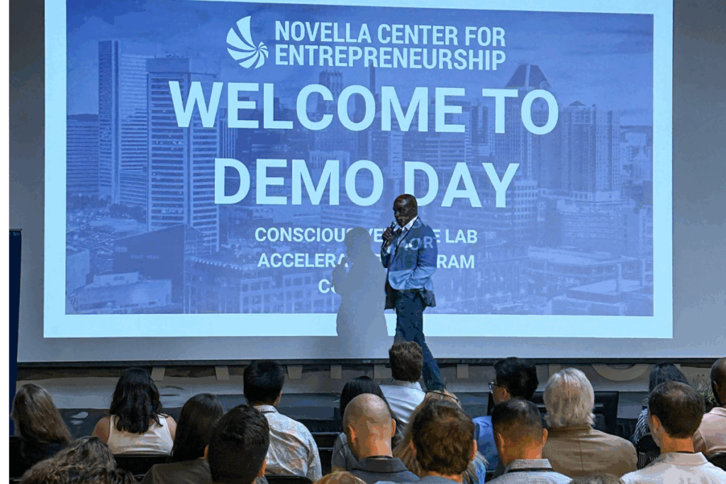 Conscious Venture Lab Demo Day highlights portraying entrepreneurs presenting impactful startups to an attentive audience of investors and mentors in a well-lit venue.