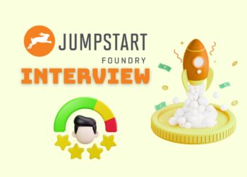 Minimalist illustration representing a founder preparing for a Jumpstart Foundry Accelerator Interview — laptops open, notes on the desk, focused atmosphere.