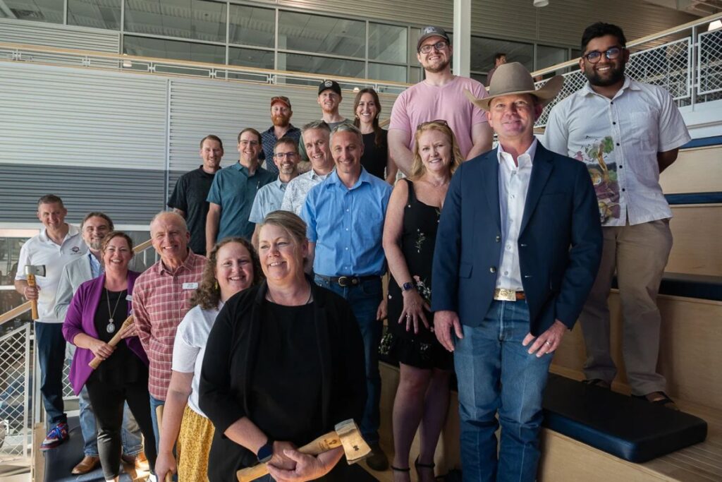 Wildfire Labs team photo showcasing a diverse group of passionate professionals smiling together in their collaborative workspace, highlighting the company’s dynamic and inclusive culture. 