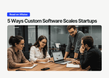 Team of startup founders collaborating around a laptop in a modern glass-walled office, discussing charts on the screen under the headline “5 Ways Custom Software Scales Startups.”
