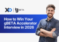 smiling founder in denim shirt beside banner reading “How to Win Your gBETA Accelerator Interview in 2026” with XRaise and gBETA logos