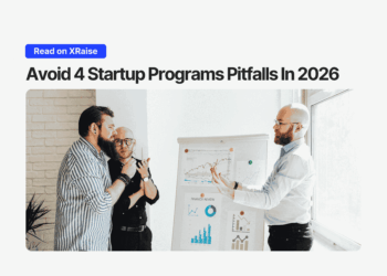 Team reviewing charts on a whiteboard while discussing startup programs pitfalls