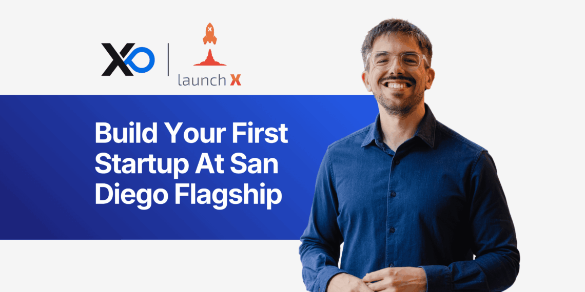 Apply to San Diego Flagship accelerator program with a smiling founder standing beside the “Build Your First Startup at San Diego Flagship” banner