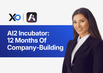 Apply to AI2 Incubator banner showing a woman founder in a blazer next to text about 12 months of company-building