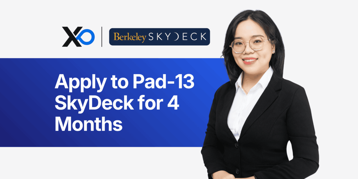 Smiling female founder in a blazer beside a banner inviting entrepreneurs to apply to Berkeley SkyDeck’s Pad-13 4-month program.