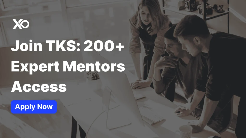 Apply to TKS World In-Person Program banner showing a team collaborating around a computer with expert mentors access