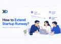 Startup runway extension visual showing founders reviewing runway, cash balance, and savings metrics to reduce burn without raising more