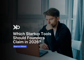 Founder working on a laptop with XRaise branding and text about choosing a startup tool stack in 2026