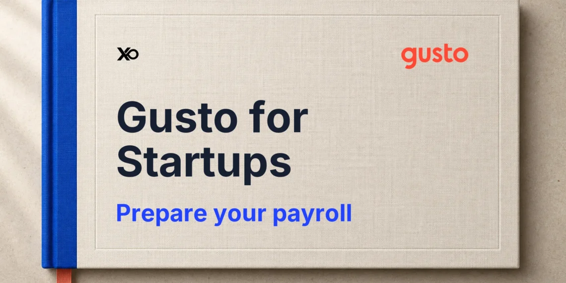 Gusto payroll preparation handbook in ivory with a blue spine and coral bookmark.