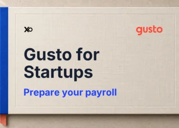 Gusto payroll preparation handbook in ivory with a blue spine and coral bookmark.